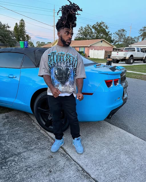 Ant standing by a blue car